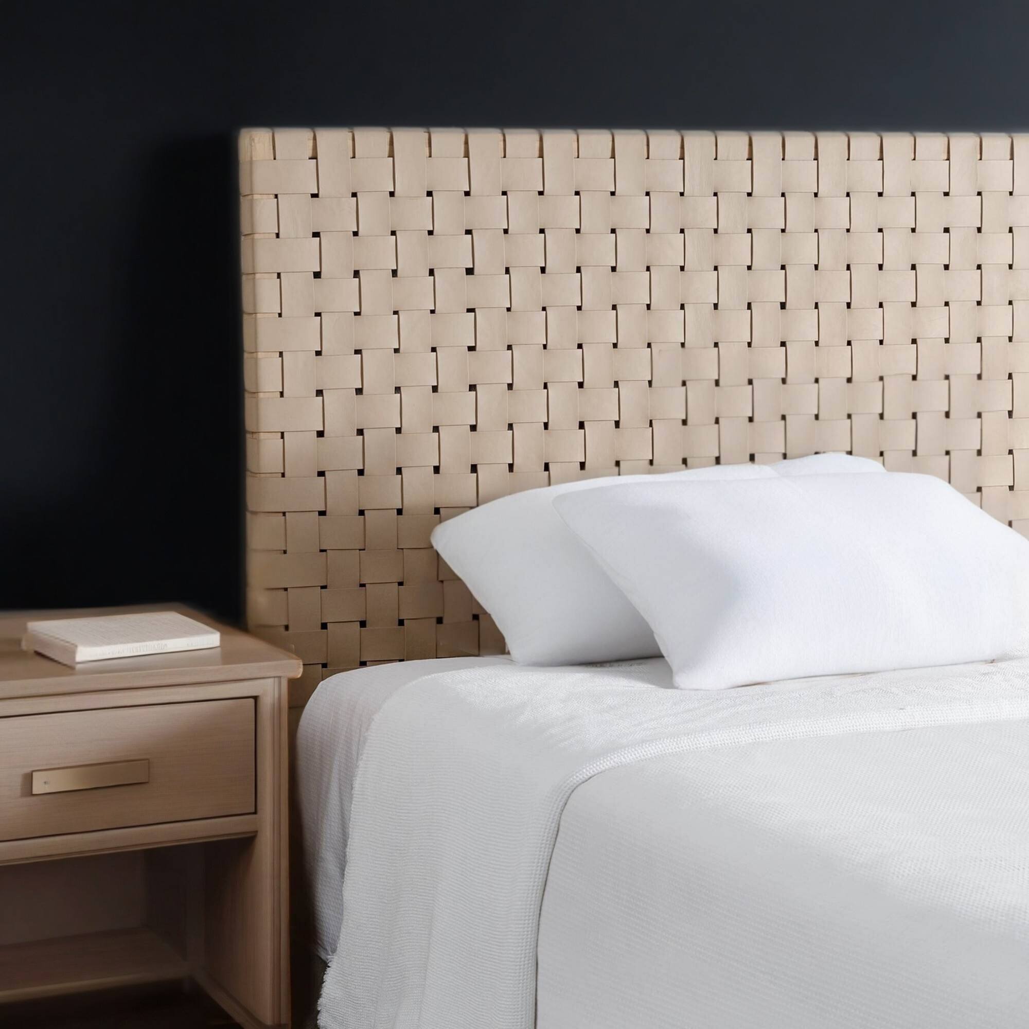 Bed with woven headboard and nightstand in a bedroom setting