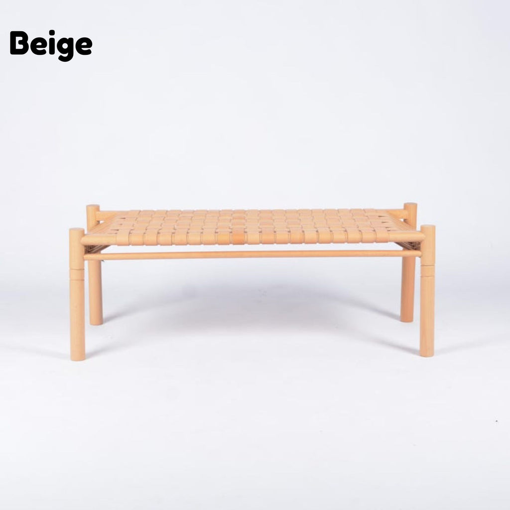 A low rectangular woven chair or bench in beige, featuring a light natural wood frame and a woven seat, shown against a plain white background with the word 'Beige' in the top left corner.
