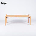 A low rectangular woven chair or bench in beige, featuring a light natural wood frame and a woven seat, shown against a plain white background with the word 'Beige' in the top left corner.