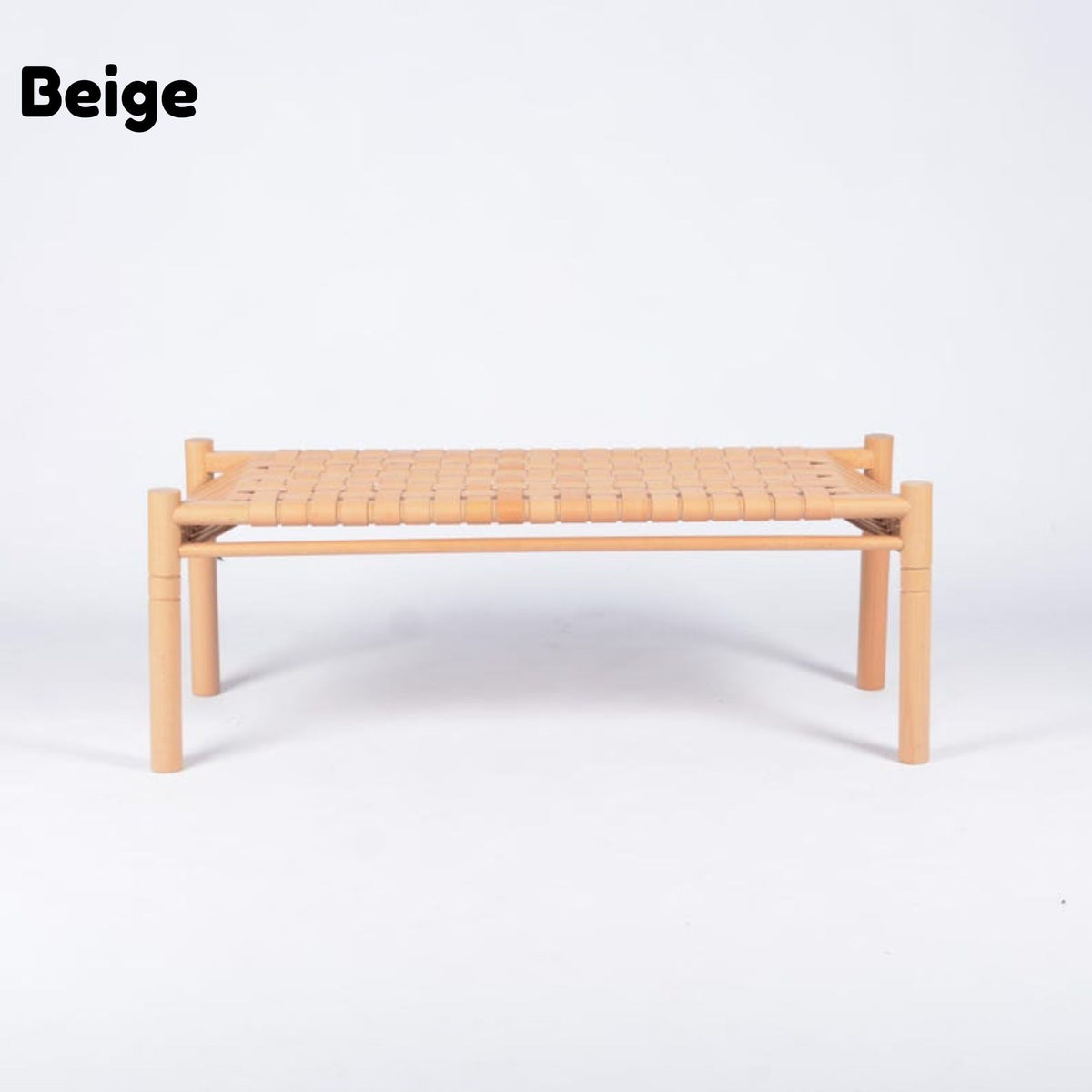 A low rectangular woven chair or bench in beige, featuring a light natural wood frame and a woven seat, shown against a plain white background with the word 'Beige' in the top left corner.