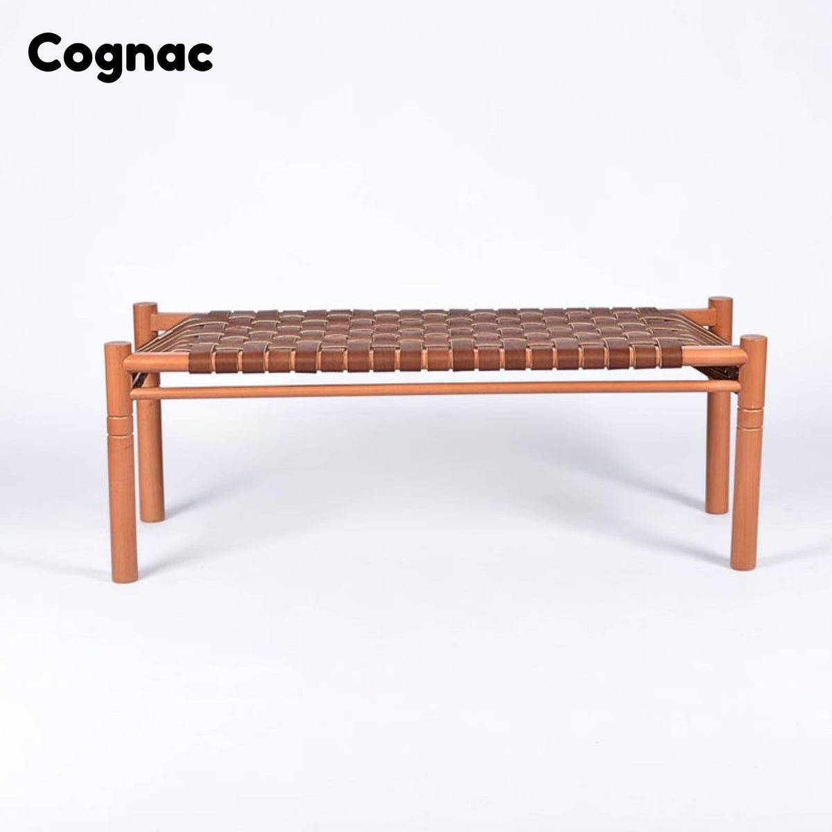 A low bench with a warm cognac wood frame and a woven brown leather seat, shown on a clean white background with the Cognac brand name in the top left corner.