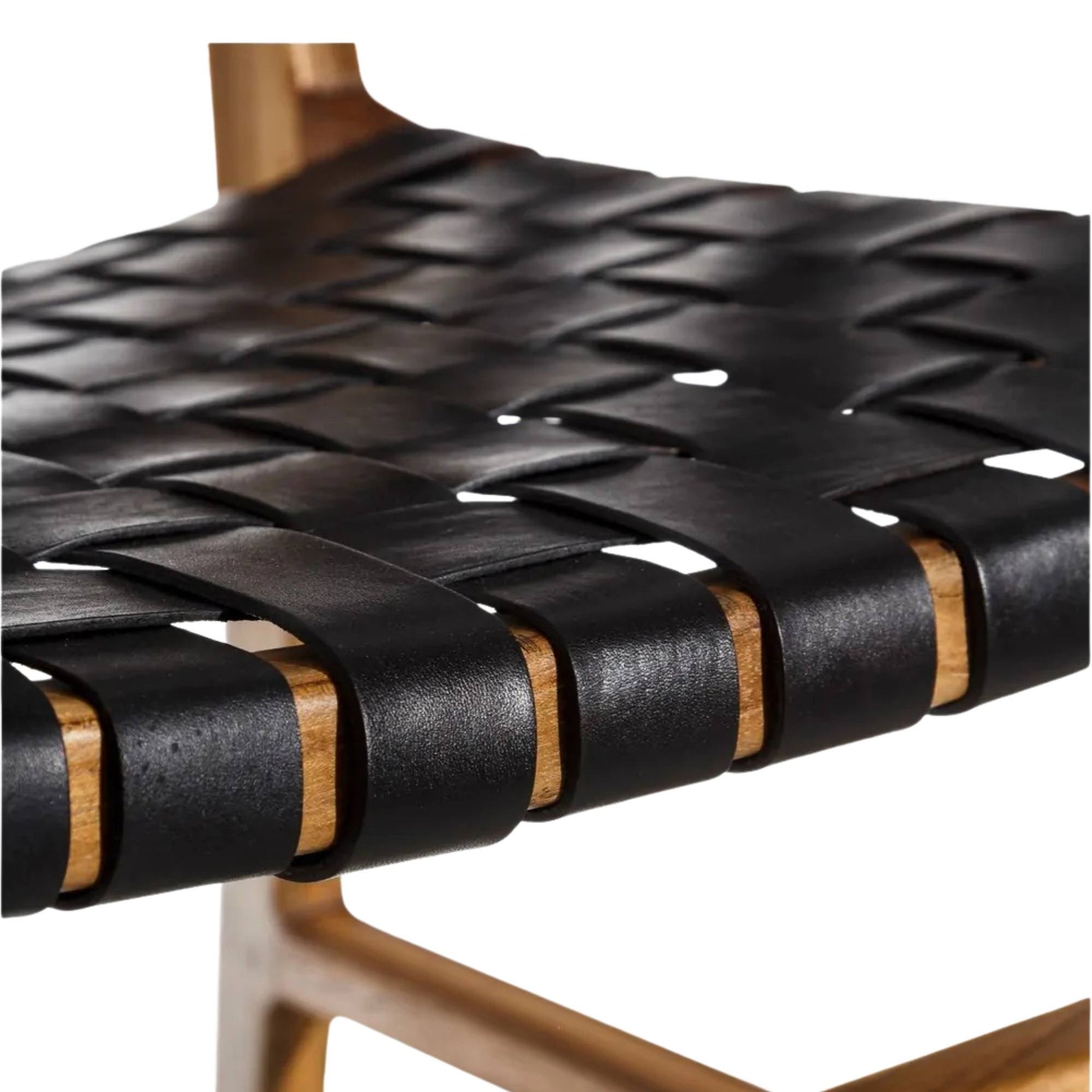Close-up of a woven black leather seat on a chair with a white background