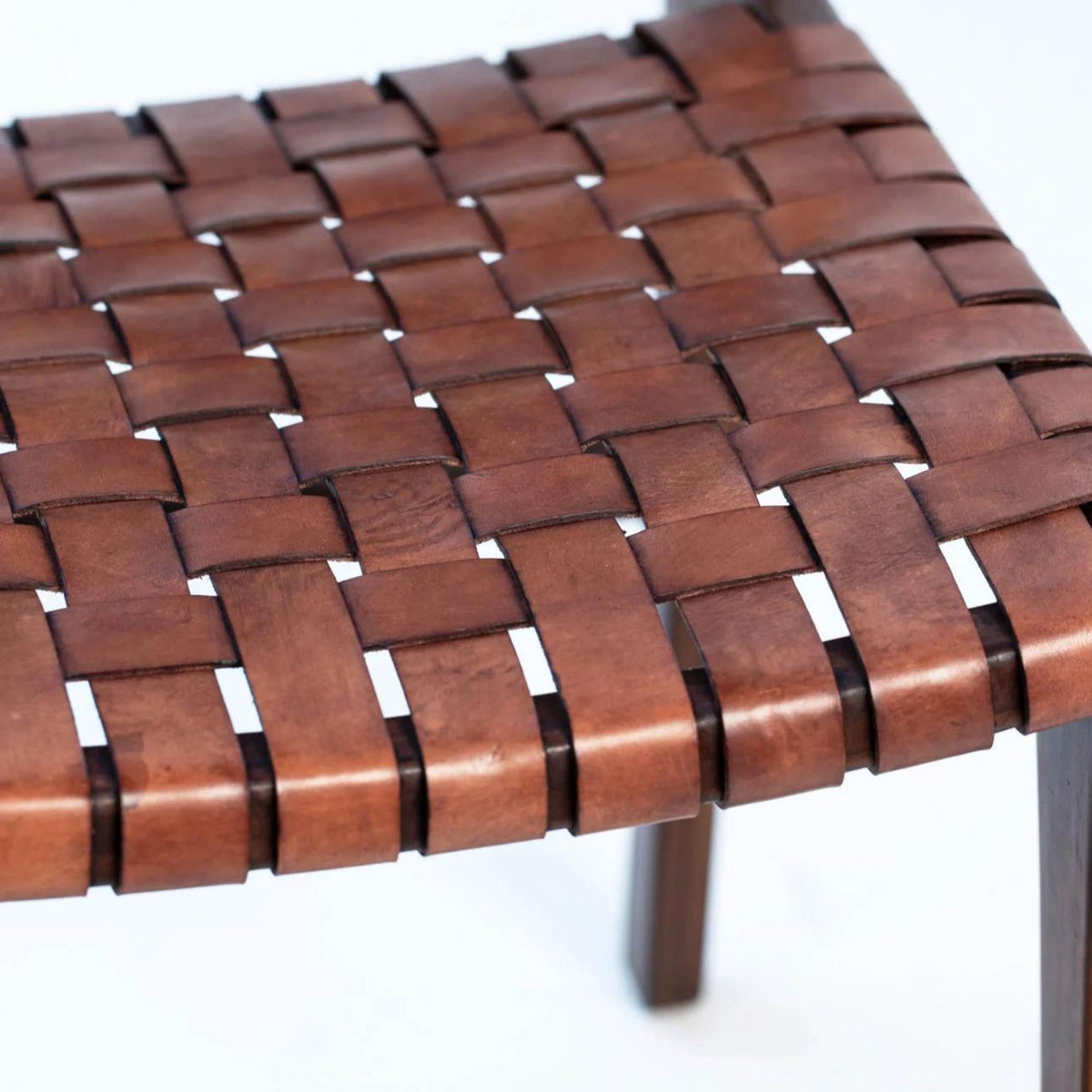 Close-up of a woven wooden table top with a white background