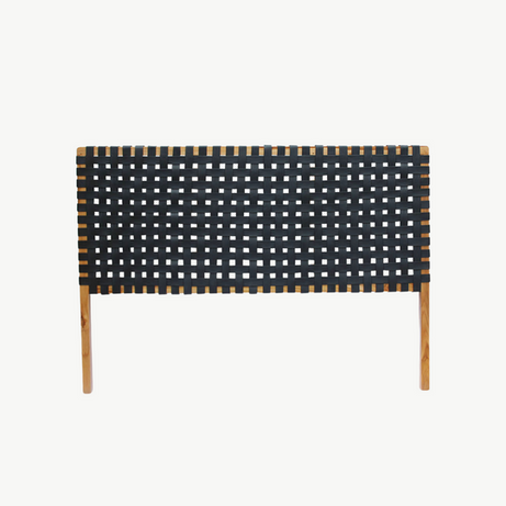 Detailed focus on the texture of the leather straps in a classic woven headboard